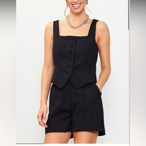 Skies are blue square neck vest and tailored pintuck shorts matching black set